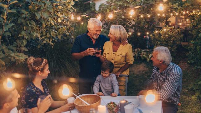family celebrating outside at dinner