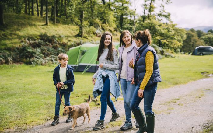 family walking dog camping