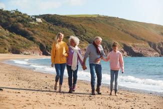 family walking on the beach holding hands in Canada