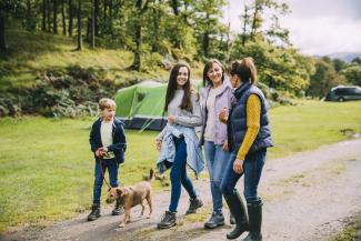 family walking dog camping