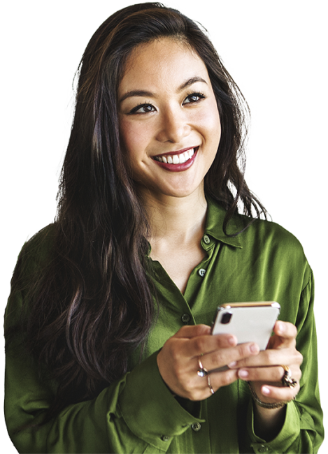 woman with green top holding phone smiling