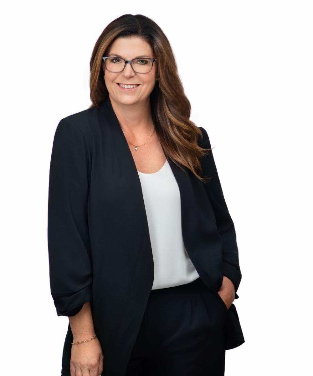 Kimberly Bay in black jacket and white shirt